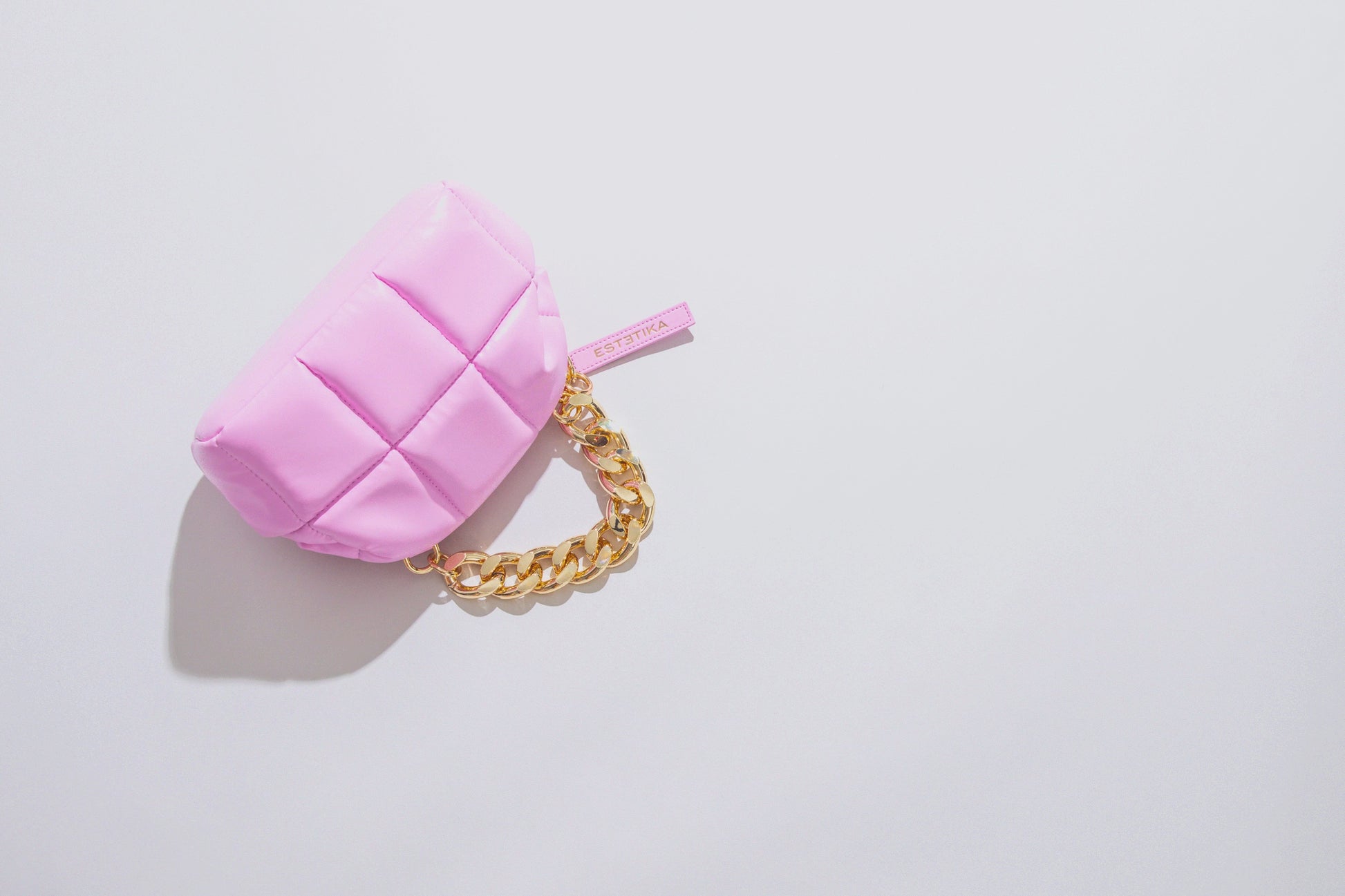pink puffy clutch video showing makeup and skincare going in and out